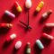 Medication Time Concept Pills Arranged as Clock Face on Red Background, Healthcare Schedule and Reminder